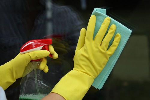 Cleaner carrying out safe cleaning tasks with protective equipment